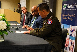 LTC Kim and Tracy Doughty sign the Huntsville Hospital ceremonial MOA. 