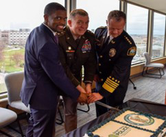 Mayor Carter, MG Manke, and Chief Henry cut the cake.