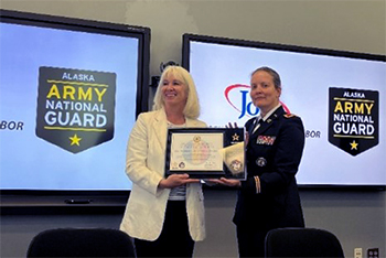 COL Johnson presents the PaYS Partnership plaque to Commissioner Munoz, recognizing the Alaska Department of Labor and Workforce Development as a PaYS Partner.