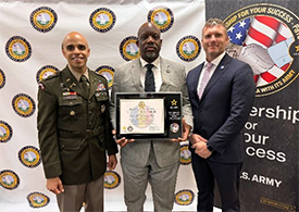 LTC Ramos, Mr. Freeman, and Mr. Lewin II pose with the ceremonial plaque.