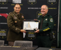 MAJ William Wiseman presents Sheriff Rick Staly with a Plaque from Army PaYS. 