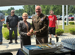 Ms. Richardson and LTC McCart cut the cake 