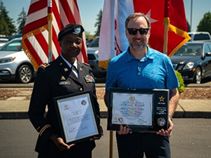 (l-r)MAJ Stephani Norman, Executive Officer, Seattle Recruiting Battalion and Philip Prothero, President and COO, ACU pose with the ceremonial plaque