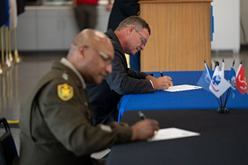 James Derwinski and MG Rodney Boyd signed the memorandum of agreement establishing partnership