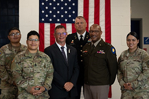 Soldiers join MG Rodney Boyd and Mr. James Derkinski in a picture after the ceremony
