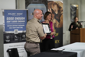 LTC Justin Ducote and Trish Mowry presenting the plaque of partnership