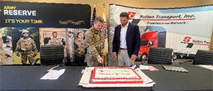 CPT Matthew Olson and Cliff Sutton cut ceremonial cake