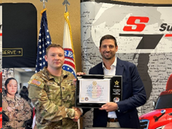 CPT Matthew Olson and Cliff Sutton hold the ceremonial plaque that displays the partnership between Army PaYS and Sutton Transport Inc. 