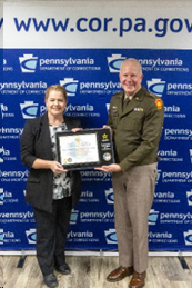 MG Schindler presents Dr. Harry with plaque and certificate