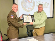 LTC Swoboda presents the PaYS plaque to Mr. Ellis, recognizing O'Reilly Auto Parts as a PaYS partner. 