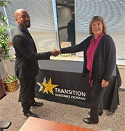 (l-r) Frank McNeil shakes hands with Julie Cunningham, TAP Manager, Ft. Sill.