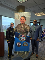 1SG/Police Officer Jessica Stiffarm and Samuel Armstrong stand front of her pull up in MNARNG uniform.