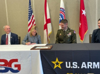 Mrs. Keri Mungo signs the SABG ceremonial MOA with LTC Miles