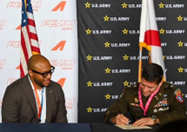 LTC Oliveira signs the FEAM Aero ceremonial MOA, Mr. Murphy awaits his turn to sign. 