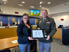 LTC Sadoski and Ms. Briceno exchange the PaYS plaque