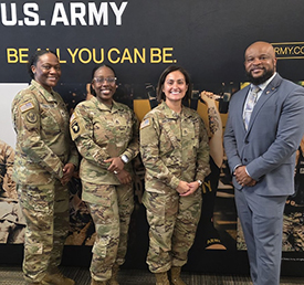 Marketer Victor poses for a picture with recruiters from the Greenville recruiting station