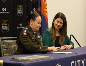 LTC Wiggins and Mayor Romero signing the agreement