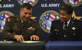 GEN John Andonie, Commanding General, Washington DC Army National Guard, signs MOA as Chief Pamela Smith, Chief of Police Metropolitan Polce Department looks on