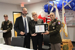 Jim Wojciechowski, Stacy Winsett, and LTC Ramon Ramos proudly pose with the Army PaYS ceremonial plaque during the official signing ceremony between RATP Dev USA and the U.S. Army.