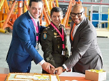 Commissioner Cabrera, LTC Oliveira, and Mr. Murphy cut the cake following the ceremony.