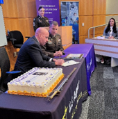 Adam Holton and LTC Oliver Karp sign the memorandum of agreement establishing partnership  