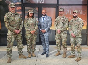 Victor Fleming stands with SFC Bond and recruiters in front of the Gardner Recruiting Station.