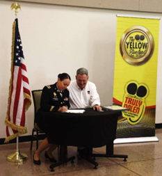 LTC Wiggins signs the ceremonial agreement. 