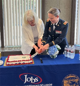 COL Johnson and Commissioner Munoz cut the cake to celebrate 