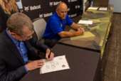 Mr. Roy Greco, Chief Digital Officer, Bobcat, and CSM Jason Magnuson, Senior Enlisted Advisor, State of NDARNG, sign the PaYS Ceremonial Agreement.