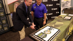 Mr. Greco cuts the cake with CSM Magnuson following the official portion of the ceremony, finalizing the partnership between Doosan Bobcat and PaYS.