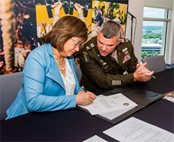 Ms. Esparza and COL Norton sign the ceremonial agreement. 