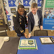 LTC Milligan and Mr. Henry cut the cake