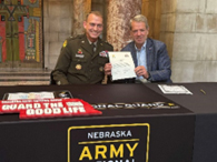 (l-r) MG Strong and Gov Pillen with the signed agreement 