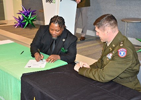 Mr Parker, and LTC Miles sign the Army PaYS partnership agreement